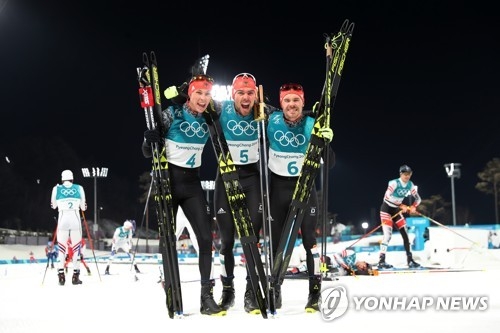 German Nordic combined skiers Johannes Rydzek (C), Fabian Riessle (R), and Eric Frenzel celebrate after finishing the individual Gundersen large hill/10km competition at the PyeongChang Winter Olympics in PyeongChang, Gangwon Province, on Feb. 20, 2018. (Yonhap)