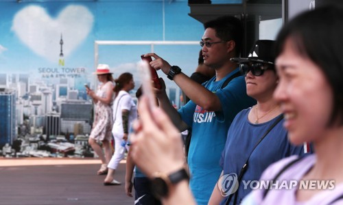 This July 2018 file photo shows Chinese tourists visiting N Seoul Tower on Mount Nam in Seoul, one of the top tourist spots in the South Korean capital. (Yonhap)