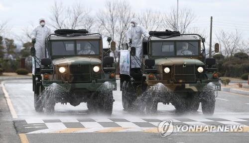 Quarantine vehicles from the Army's 53rd Infantry Division spray disinfectant around Ulsan Airport in Ulsan, 410 kilometers southeast of Seoul, on March 3, 2020, joining the nationwide fight against the novel coronavirus. (Yonhap)