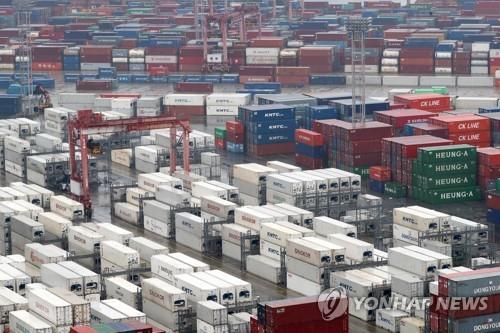 The file photo shows stacks of import-export cargo containers at South Korea's largest seaport in Busan, around 450 kilometers southeast of Seoul. (Yonhap)