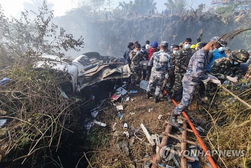 This EPA photo shows rescue teams working at the wreckage of a Yeti Airlines ATR72 aircraft after it crashed in Pokhara, Nepal, on Jan. 15, 2023. (Yonhap)