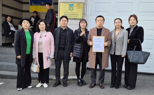 A group of North Korean defectors deliver propaganda leaflets to the Embassy of Ukraine in Seoul on Nov. 11, 2024, in this photo provided by their group, called the "Defectors' Propaganda Corps." (PHOTO NOT FOR SALE) (Yonhap)