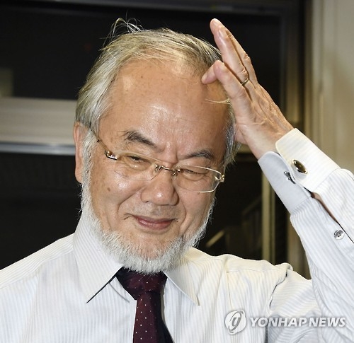 수상소식에 모여든 취재진 앞에서 쑥스러워하는 오스미 교수(AP=연합뉴스)