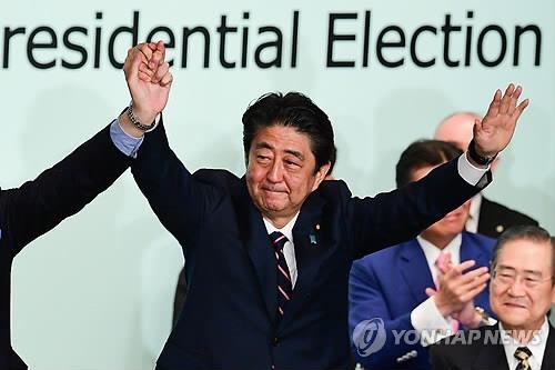 아베 신조(安倍晋三) 일본 총리가 지난 20일 자민당 총재선거에서 승리를 거둔 뒤 도쿄의 자민당 당사에서 두 손을 들고 환호하는 모습 [AFP=연합뉴스 자료사진] 