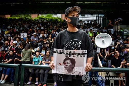 캐리 람 홍콩 행정장관의 사진을 들고 시위를 벌이는 홍콩 청년 [AFP=연합뉴스] 