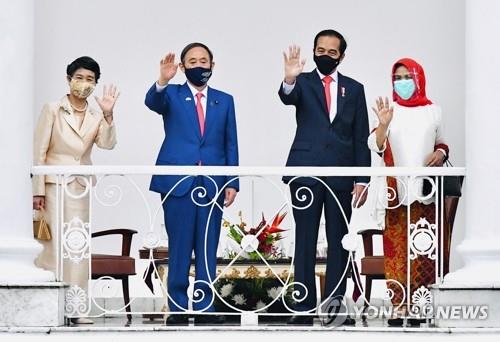 (자카르타 AP=연합뉴스) 스가 요시히데(왼쪽 두 번째) 일본 총리 부부가 20일 인도네시아 수도 자카르타 외곽 보고르 대통령궁에서 조코 위도도(오른쪽 두 번째) 인도네시아 대통령 부부와 함께 나란히 서서 손을 흔들고 있다. leekm@yna.co.kr