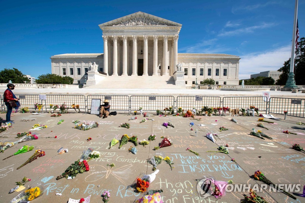 루스 베이더 긴즈버그 대법관을 추모하는 꽃이 놓인 미국 연방대법원 앞 거리 [AFP=연합뉴스]