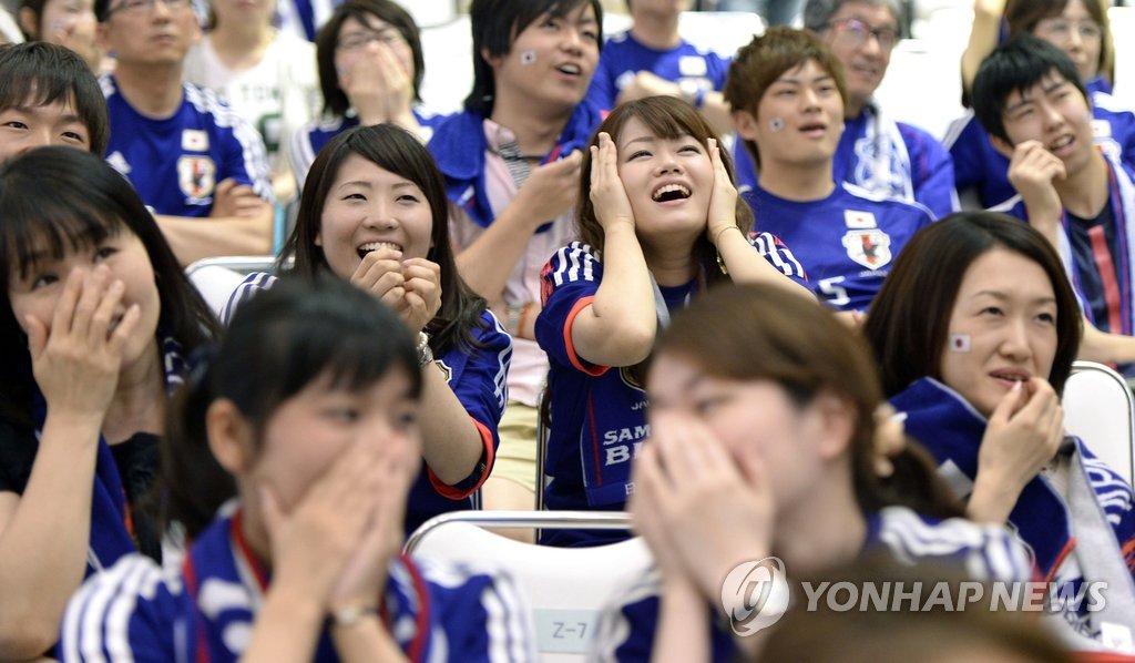 14일(브라질 현지시간) 치러진 2014 브라질 월드컵 축구 조별리그 C조 1차전에서 일본이 코트디부아르에 1-2로 역전패하자 오사카(大阪)의 한 백화점에서 단체 관전중인 일본 팬들이 아쉬워하고 있다. (연합뉴스 DB)