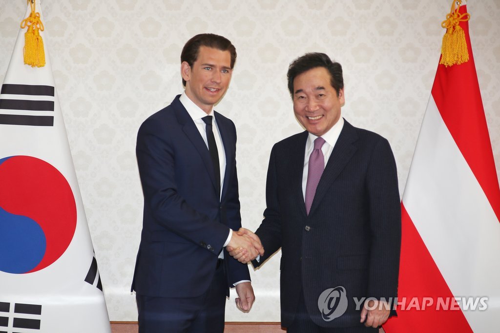 South Korean Prime Minister Lee Nak-yon (R) shakes hands with Austrian Chancellor Sebastian Kurz at the Government Complex in Seoul on Feb. 14, 2019. (Yonhap)