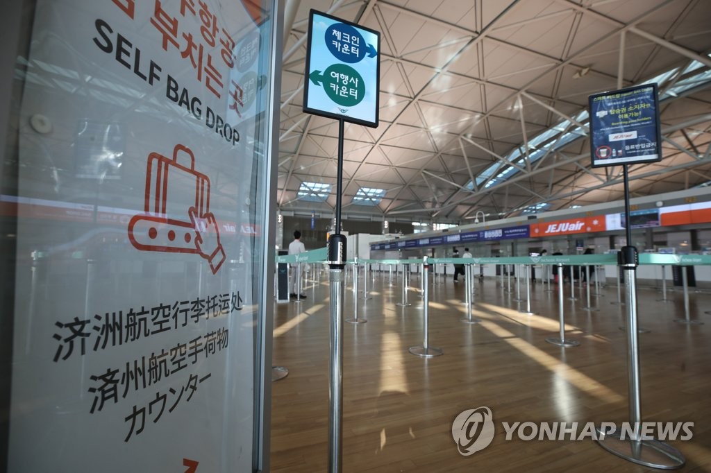 This photo taken on Feb. 5, 2020, shows airline counters of low-cost carriers with few passengers checking in for flights at Incheon International Airport. (Yonhap)