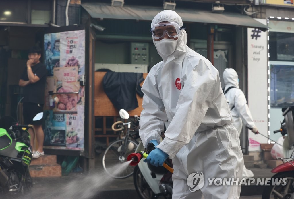 Quarantine officials disinfect areas near a church tied to spiking virus cases in Seoul's northern district of Seongbuk on Sept. 24, 2020, ahead of the Chuseok fall harvest holiday. (Yonhap)