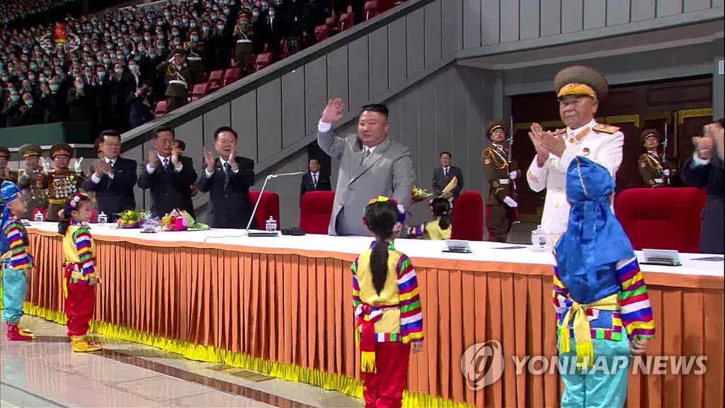 In this photo captured from the North's Korean Central Television on Oct. 12, 2020, North Korean leader Kim Jong-un (C) waves during a mass gymnastics and artistic performance at the May Day Stadium in Pyongyang the previous day in celebration of the 75th founding anniversary of the ruling Workers' Party. (For Use Only in the Republic of Korea. No Redistribution) (Yonhap)
