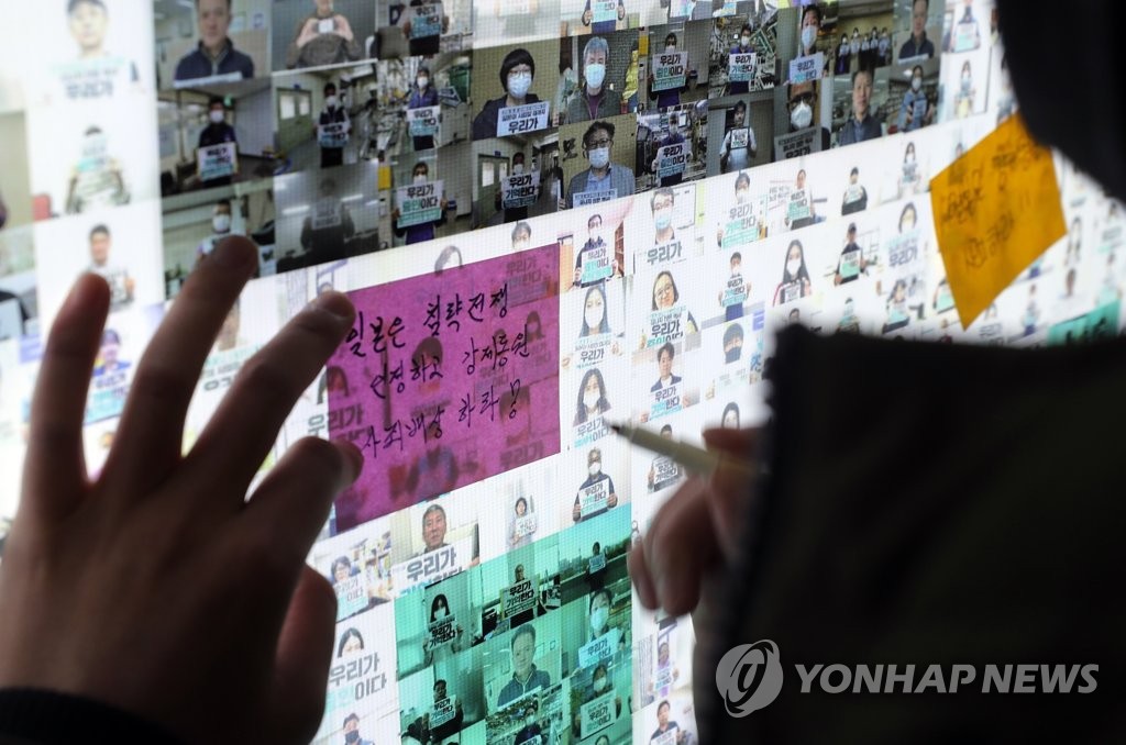 일본 사죄 광고위에 응원 포스트잇 붙이는 대학생들