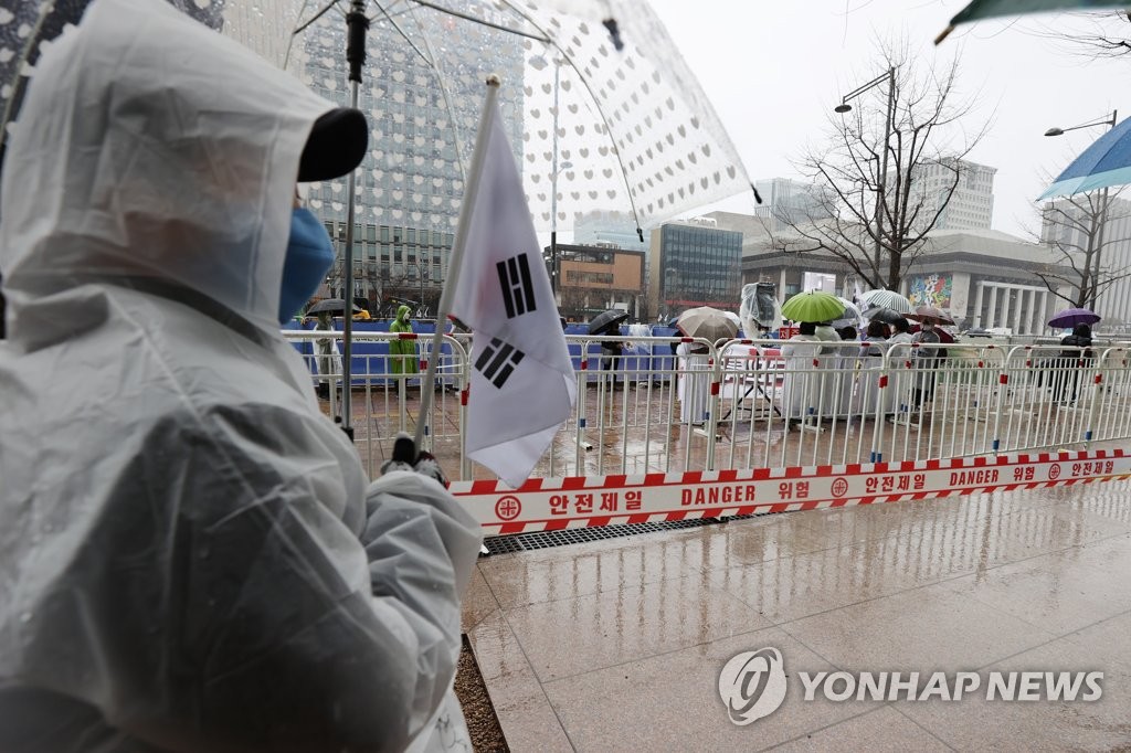 A group of protesters stages a rally at Gwanghwamun Square in Seoul on March 1, 2021. (Yonhap)