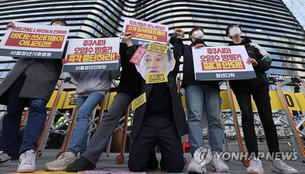 South Korean civic activists stage a protest against the Japanese government's decision to discharge radioactive water from the crippled Fukushima nuclear plant into the Pacific Ocean during a news conference in front of the Japanese Embassy in Seoul on April 13, 2021. (Yonhap)