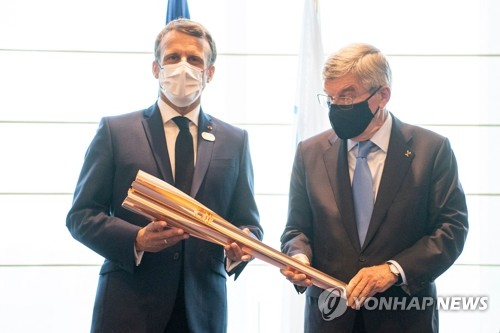 도쿄올림픽 개회식 전 성화봉 건네받는 마크롱