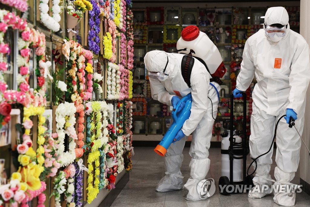 Quarantine workers disinfect a columbarium in Suwon, about 45 kilometers south of Seoul, ahead of the upcoming Lunar New Year holiday that runs from Jan. 31 to Feb. 2, in this photo taken Jan. 26, 2022. (Yonhap)