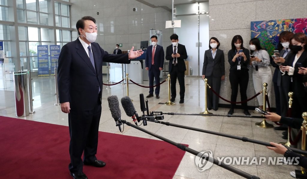 President Yoon Suk-yeol answers reporters' questions while arriving for work at the presidential office in Seoul on Oct. 4, 2022. (Pool photo) (Yonhap)