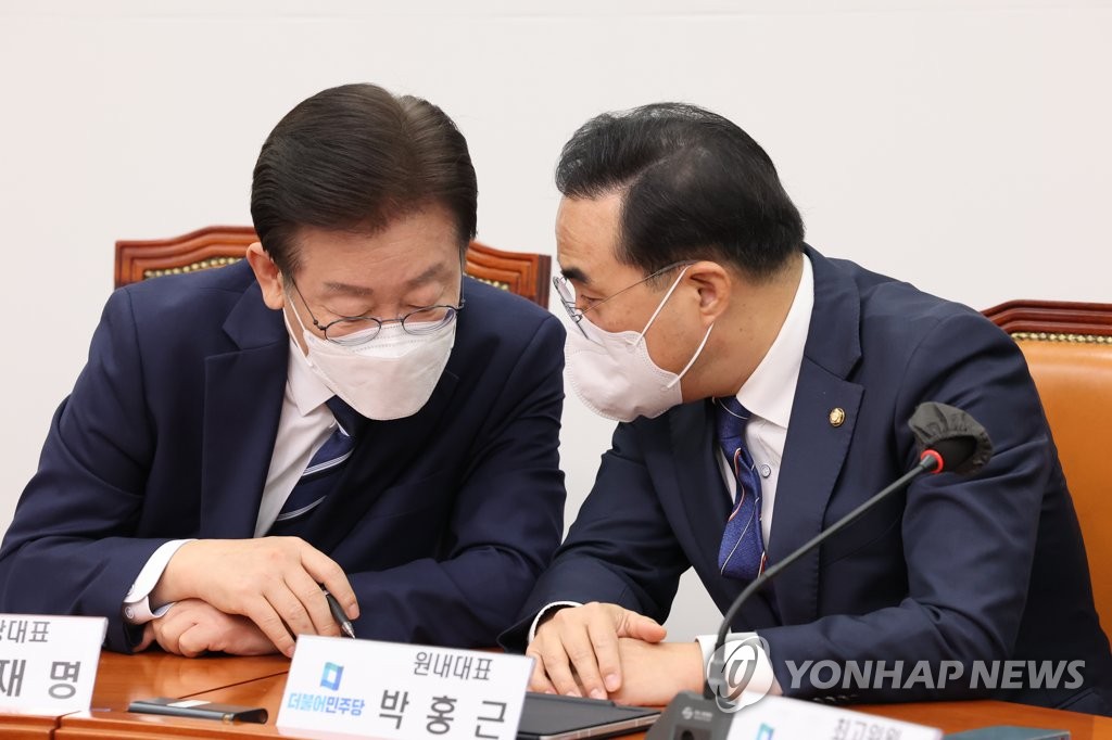 Main opposition Democratic Party chief Lee Jae-myung (L) and floor leader Park Hong-keun are in discussion during the party's Supreme Council meeting at the National Assembly on Nov. 28, 2022. (Yonhap)