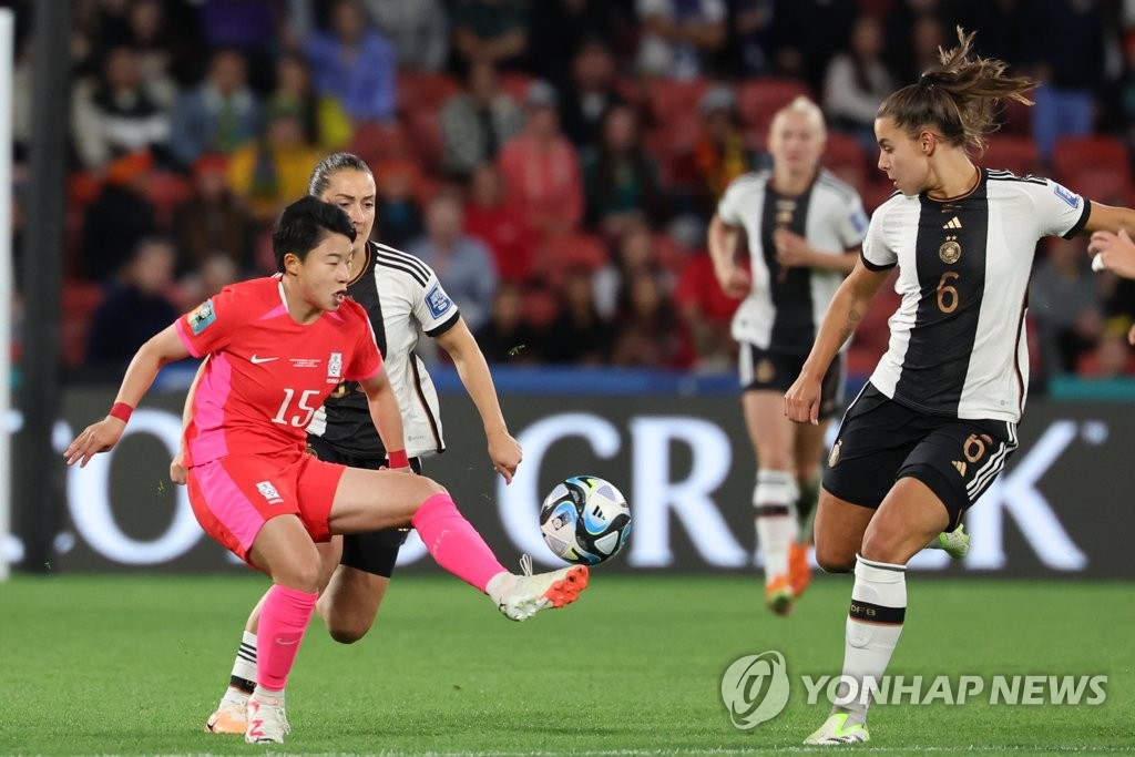 Chun Garam of South Korea (L) tries to make a pass past Lena Oberdorf of Germany (R) during the teams' Group H match at the FIFA Women's World Cup at Brisbane Stadium in Brisbane, Australia, on Aug. 3, 2023. (Yonhap)