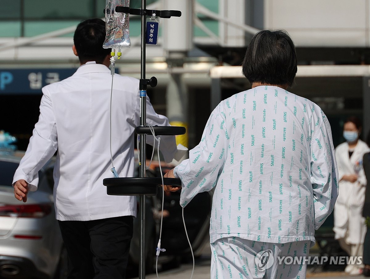 La imagen de archivo, tomada el 9 de mayo de 2024, muestra a una paciente y un doctor en el Hospital de la Universidad Nacional de Seúl, en el centro de la capital surcoreana.