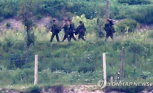 This file photo, dated Aug. 26, 2015, shows a group of soldiers walking out of a sentry post in Kaepung on the North's western front-line. (Yonhap)