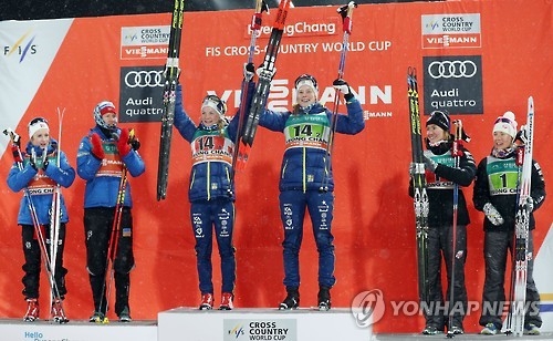 Elin Mohlin (L on the center podium) and Maria Nordstroem of Norway celebrate their victory in the women's team sprint at the International Ski Federation (FIS) Cross-Country World Cup at Alpensia Cross-Country Skiing Centre in PyeongChang, Gangwon Province, on Feb. 5, 2017. (Yonhap)