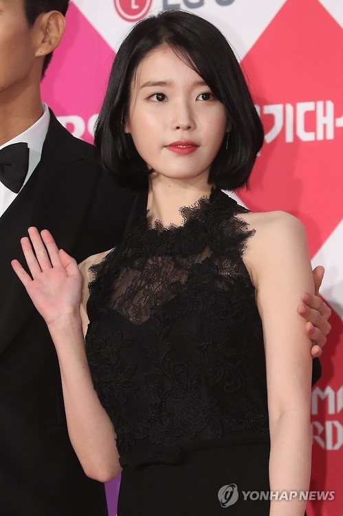 In this file photo, singer IU poses for a photo during the awards ceremony for the 2016 Drama Awards of the public broadcaster SBS in Seoul on Dec. 31, 2016. (Yonhap) 