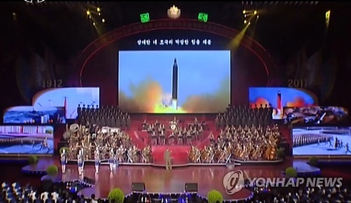 This image captured from footage by North Korea's state TV station on April 17, 2017, shows the footage of a launch of an intermediate-range Musudan ballistic missile on a giant screen during the State Merited Chorus' latest performance. (For Use Only in the Republic of Korea. No Redistribution) (Yonhap)