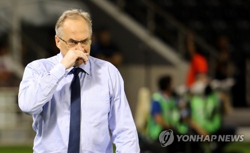 South Korea's national football team head coach Uli Stielike wipes his nose during the FIFA World Cup Asian qualifier against Qatar at Jassim Bin Hamad Stadium in Doha on June 13, 2017. (Yonhap) 