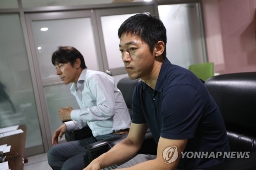 South Korean men's national team head coach Shin Tae-yong (L) and assistant coach Kim Nam-il watch the K League Classic match between FC Seoul and Pohang Steelers at Seoul World Cup Stadium in Seoul on July 12, 2017. (Yonhap)