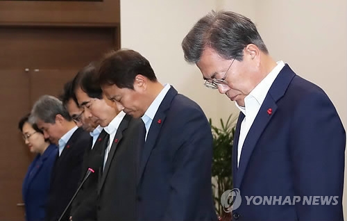 President Moon Jae-in (R) holds a moment of silence in honor of people killed in a fishing boat accident before the start of a weekly meeting with his top presidential aides at his office Cheong Wa Dae in Seoul on Dec. 4, 2017. (Yonhap)