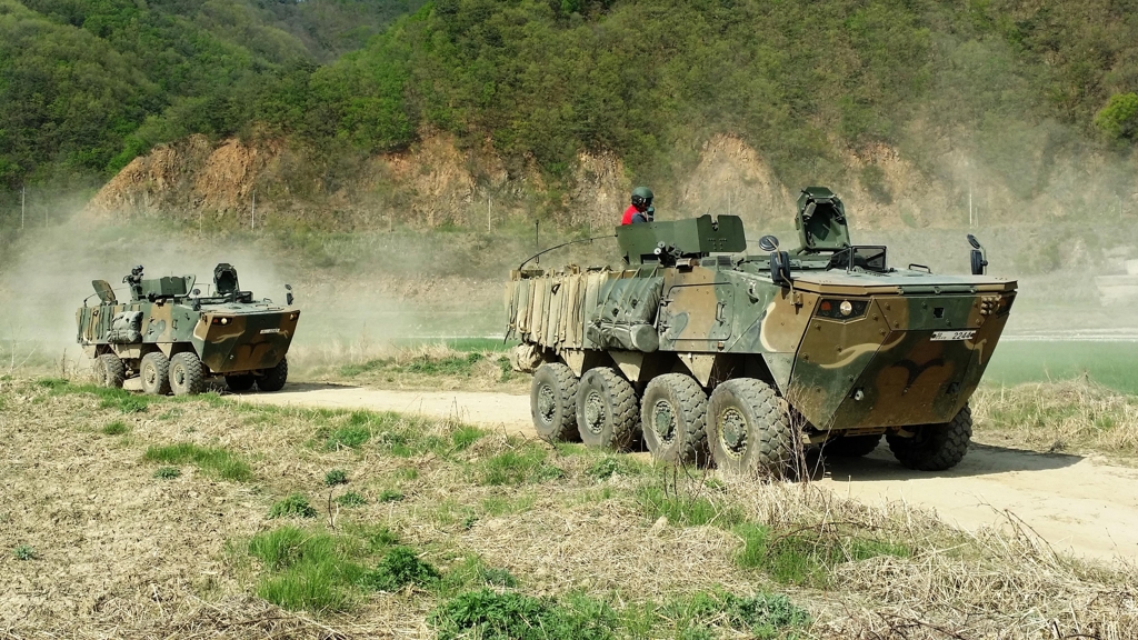 This undated photo provided by Hyundai Rotem shows two K808 (R) and K806 wheeled armored vehicles on a drill. (Yonhap)