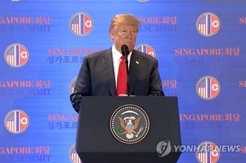 U.S. President Donald Trump speaks during a press conference in Singapore on June 12, 2018, in this photo captured from the website of The Straits Times. (Yonhap)