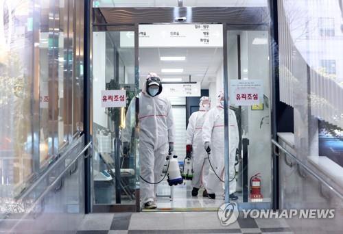 Health authorities disinfect a hospital in Busan, 450 kilometers southeast of Seoul, on Feb. 24, 2020. (Yonhap)