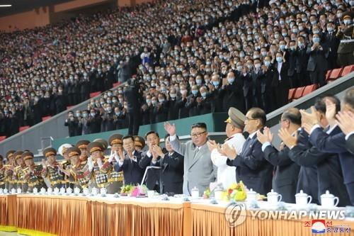 North Korean leader Kim Jong-un (7th from R) waves during a mass gymnastics and artistic performance held at the May Day Stadium in Pyongyang on Oct. 11, 2020, in celebration of the 75th founding anniversary of the ruling Workers' Party, in this photo provided by the Rodong Sinmun on Oct. 12. (For Use Only in the Republic of Korea. No Redistribution) (Yonhap)