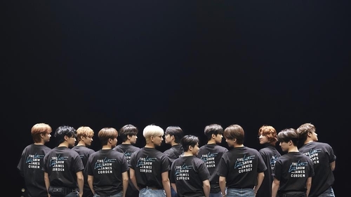 This photo, provided by Pledis Entertainment, shows members of K-pop band Seventeen in T-shirts for "The Late Late Show with James Corden," a popular American TV show. (PHOTO NOT FOR SALE) (Yonhap)