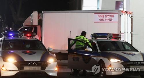 A truck carrying vials of AstraZeneca's vaccine departs from a cold chain logistics warehouse in Icheon, 80 km southeast of Seoul. under the strict guard of the Army and police on Feb. 25, 2021. (Yonhap) 