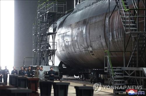 This photo, released by the Korean Central News Agency on July 23, 2019, shows North Korean leader Kim Jong-un (2nd from R) inspecting a newly built submarine. As is customary, the agency did not provide the date and location. (For Use Only in the Republic of Korea. No Redistribution) (Yonhap)