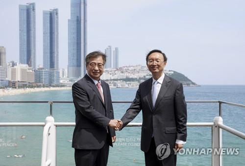 This file photo shows national security adviser Suh Hoon (L) shaking hands with Chinese Communist Party foreign affairs chief Yang Jiechi after talks in Busan, 453 kilometers southeast of Seoul, on Aug. 22, 2020. (Yonhap)