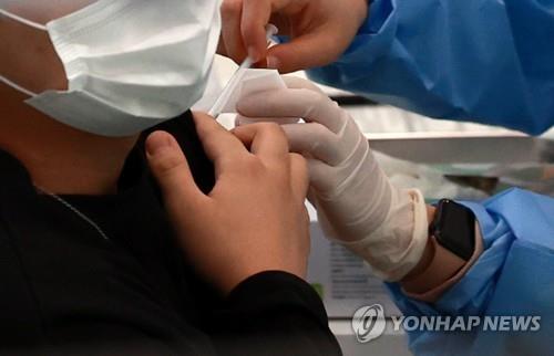 In this file photo taken on Oct. 23, 2021, a person gets a COVID-19 vaccine in Seoul. (Yonhap)