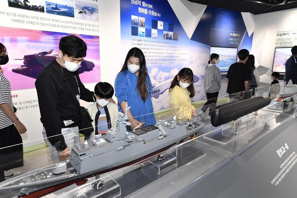 In this undated photo provided by the state-run Agency for Defense Development on April 22, 2022, visitors take a look at a new exhibition hall displaying the latest weapons system developed by the agency. (PHOTO NOT FOR SALE) (Yonhap)