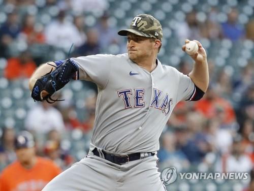In this Getty Images file photo from May 14, 2021, Wes Benjamin of the Texas Rangers pitches against the Houston Astros during the bottom of the first inning of a Major League Baseball regular season game at Minute Maid Park in Houston, Texas. (Yonhap)