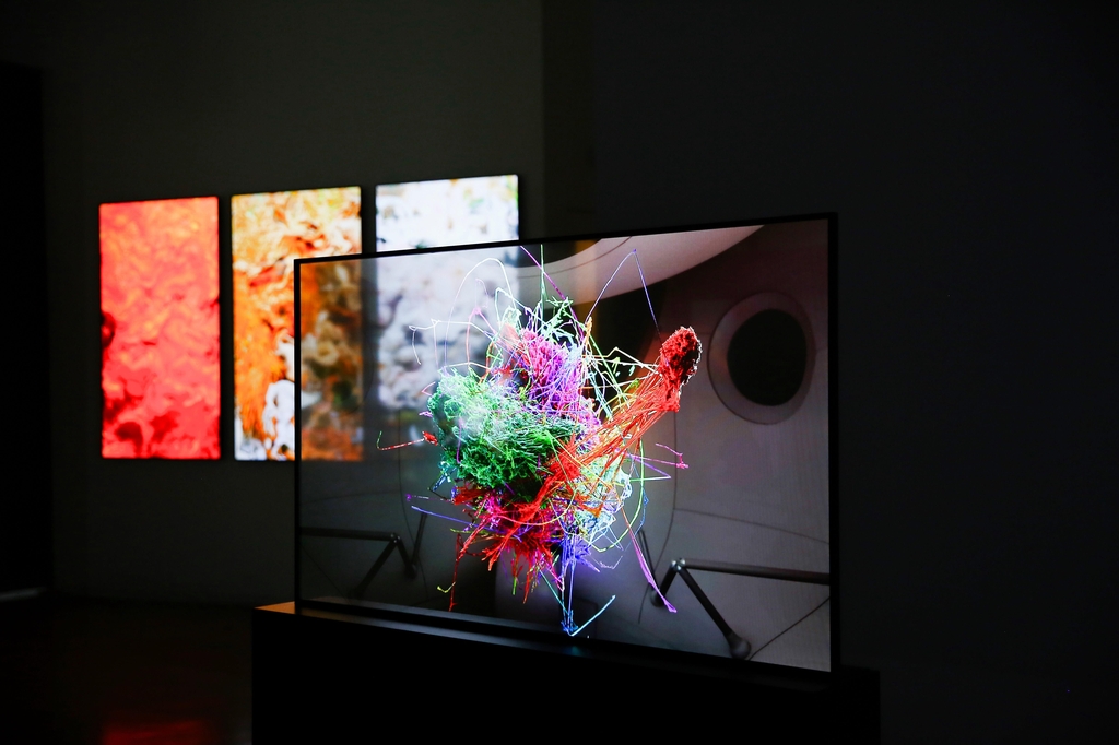 This photo, provided by LG Display Co., shows Turkish-American artist Refik Anadol's NFT collection, "An Important Memory for Humanity," on the panel maker's transparent organic light-emitting diode. (PHOTO NOT FOR SALE) (Yonhap)