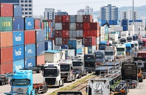 Cargo containers are piled up at an inland container depot in Uiwang, Gyeonggi Province, south of Seoul, with a row of cargo trucks parked alongside, as the strike by thousands of truckers in protest of the planned expiry of a freight rate system continued for the seventh day, in this file photo taken June 13, 2022. (Yonhap) 