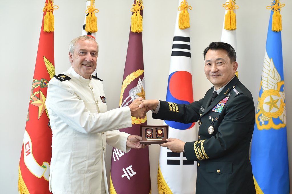 Joint Chiefs of Staff Chairman Gen. Kim Seung-kyum (R) shakes hands with Adm. Michel Hofman, the chief of defense of the Belgian Armed Forces, in Seoul on Aug. 4, 2022, in this photo released by the defense ministry. (PHOTO NOT FOR SALE) (Yonhap) 