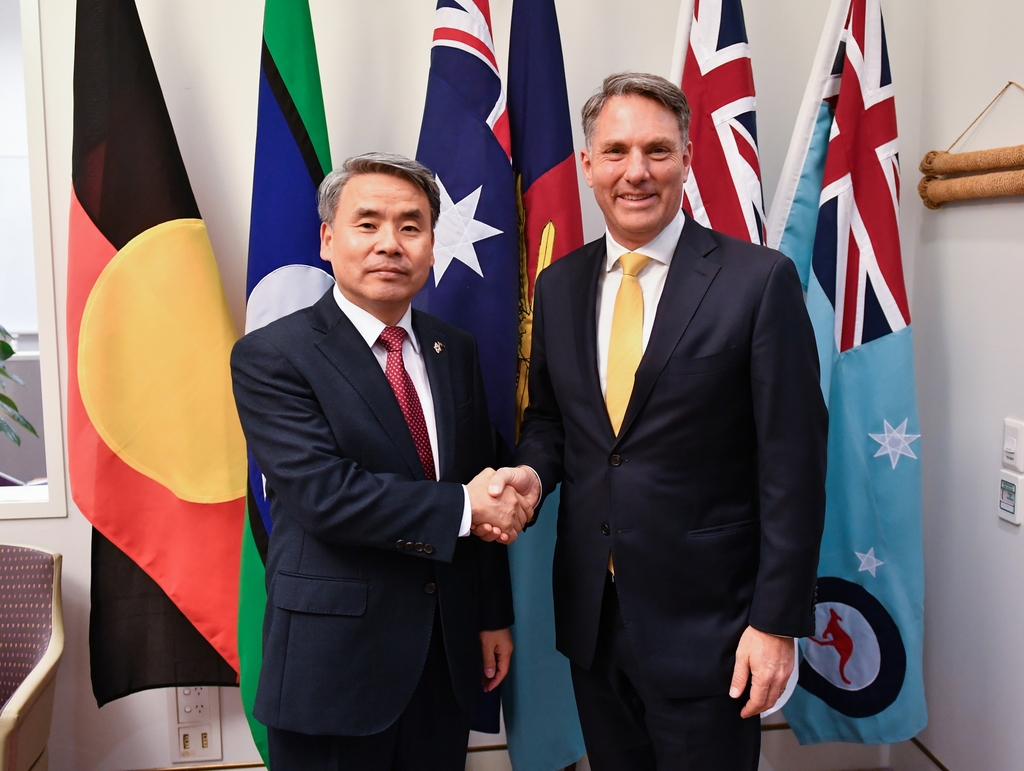 South Korea's Defense Minister Lee Jong-sup (L) shakes hands with his Australian counterpart, Richard Marles, during a meeting in Canberra on Aug. 4, 2022, in this photo released by Lee's ministry. (PHOTO NOT FOR SALE) (Yonhap)