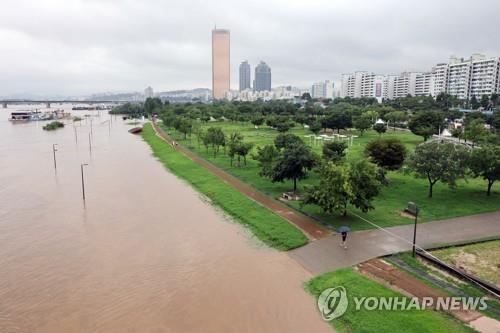A riverside park along the Han River in Seoul's Yeouido district remains submerged in floodwater on Aug. 9, 2022. (Yonhap) 