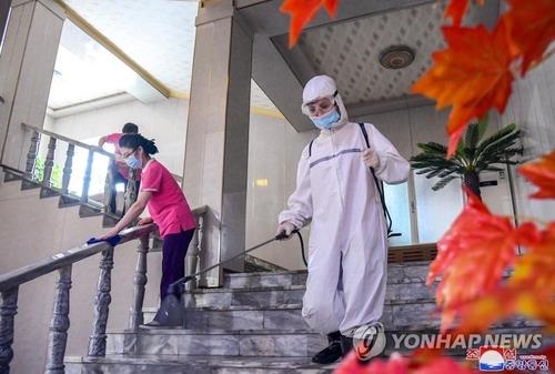 This file photo, released by North Korea's official Korean Central News Agency on July 1, 2022, shows workers sterilizing the inside of a hotel in Pyongyang. (For Use Only in the Republic of Korea. No Redistribution) (Yonhap)