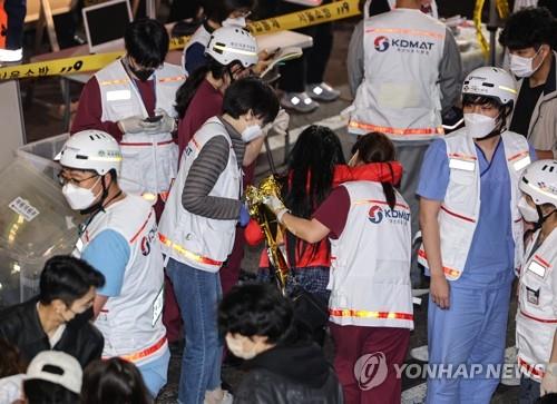 Medical workers attend to victims in Seoul's Itaewon district on Oct. 30, 2022 after a deadly stampede during Halloween celebrations the previous day.